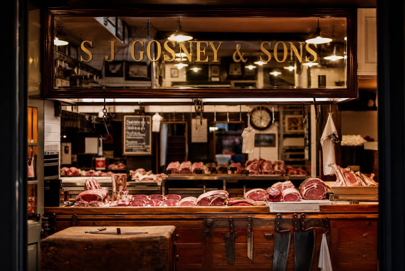 Inside S J Gosney & Sons butcher's shop, traditional counter and mirror sign